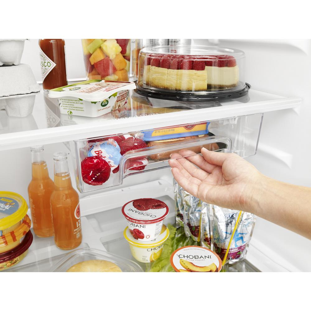 Hand reaching to open clear Flexi-Slide™ bin inside Whirlpool refrigerator with beverages and snacks in kitchen appliances collection