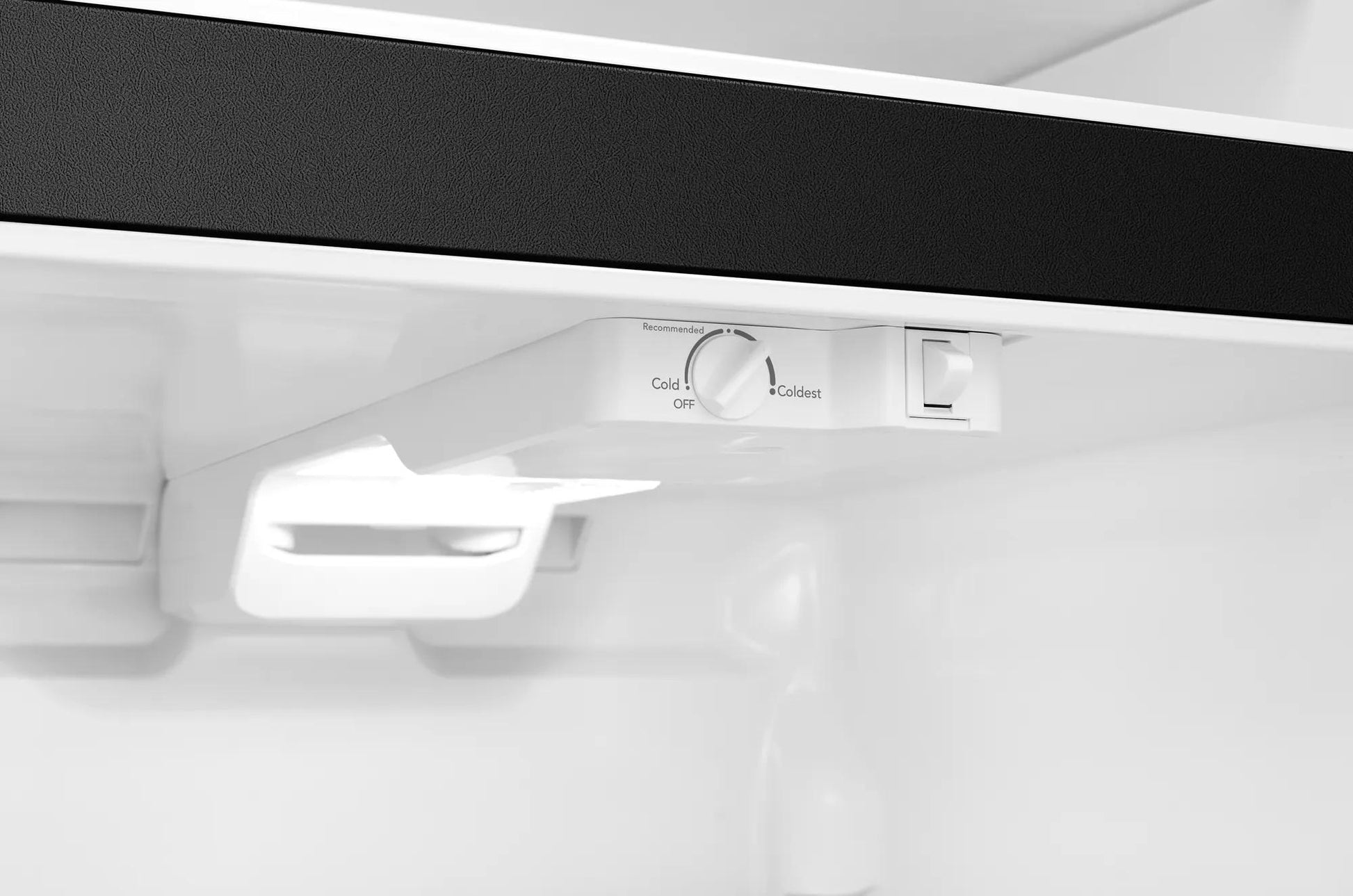 Interior control panel with adjustable temperature dial and light switch in top freezer refrigerator from Appliances collection