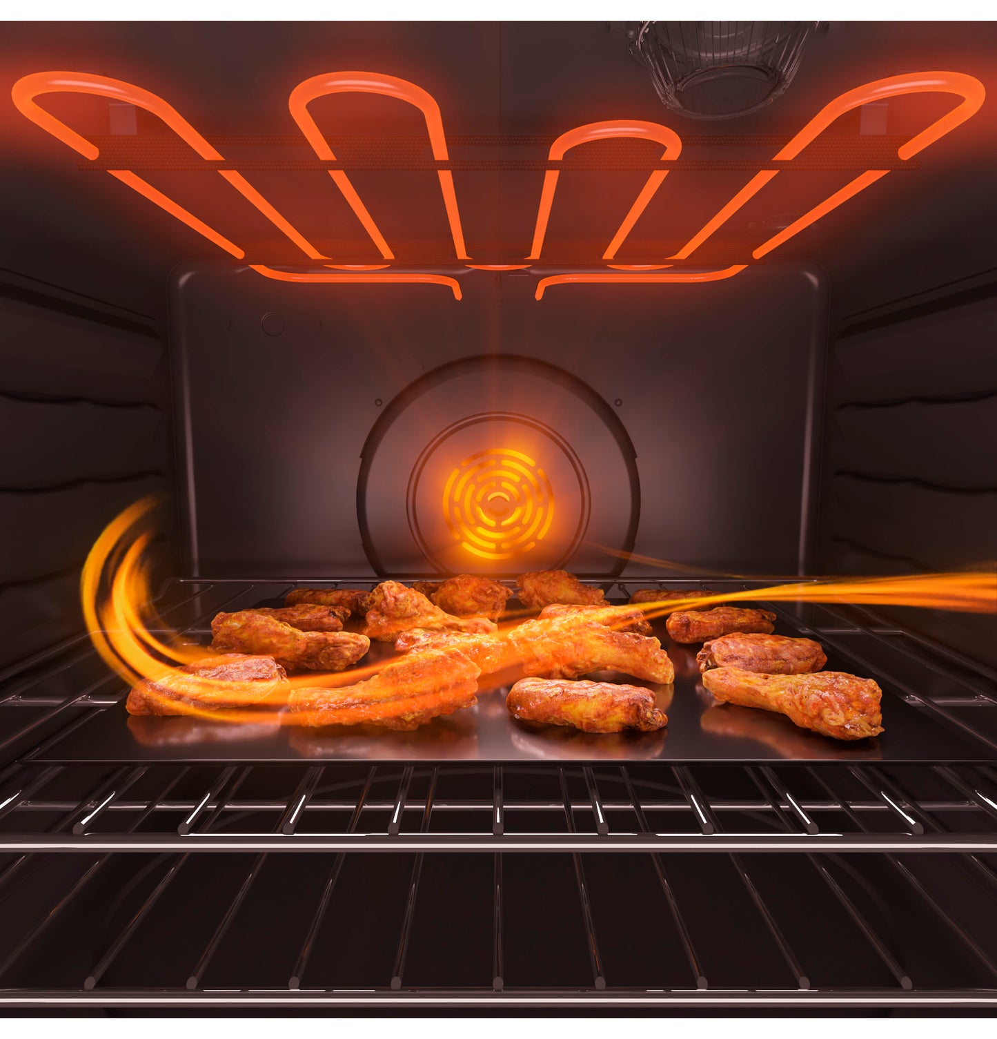 Inside view of convection oven heating and air frying crispy chicken wings with visible heating elements glowing red-orange