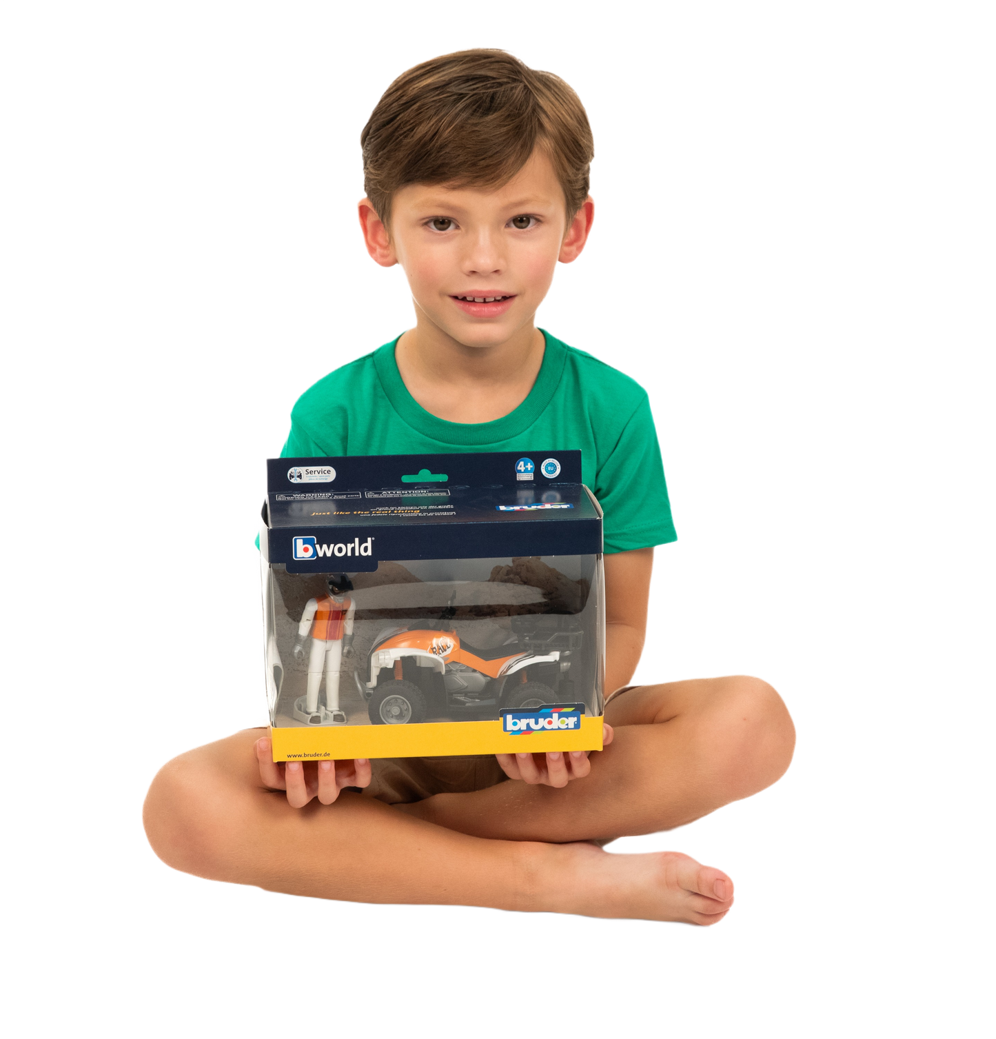 Child holding Bruder Quad Bike with Driver toy in packaging, part of Vehicles & Remote Controlled Toys collection