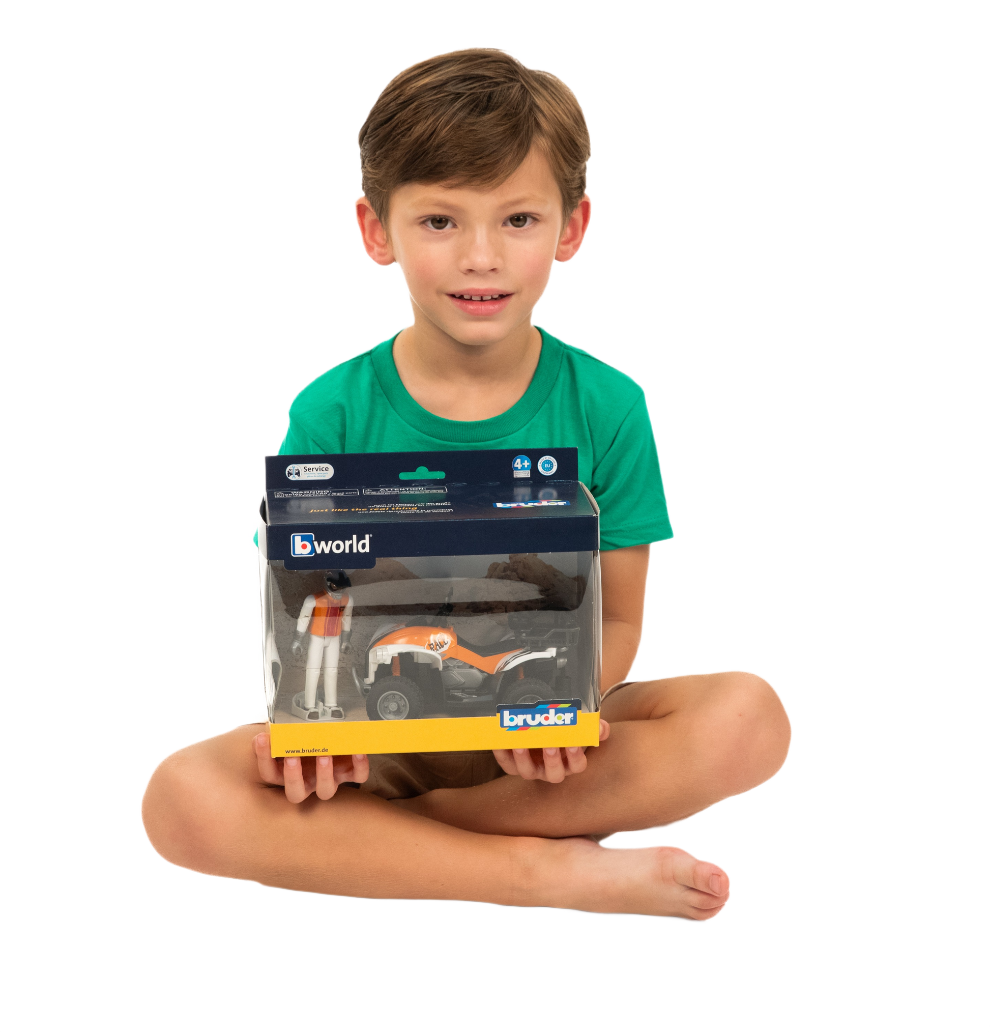 Child holding Bruder Quad Bike with Driver toy in packaging, part of Vehicles & Remote Controlled Toys collection