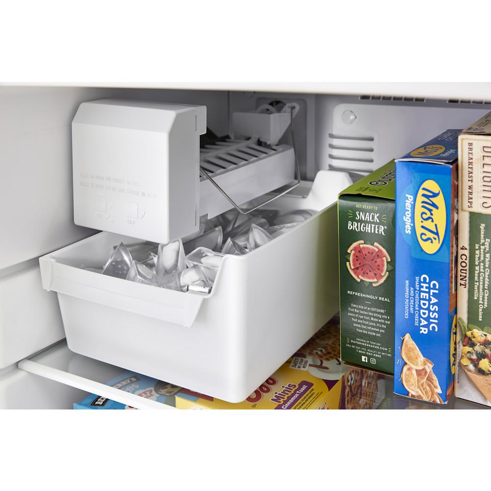 Ice maker producing ice cubes inside the freezer compartment of a top freezer refrigerator in appliances collections