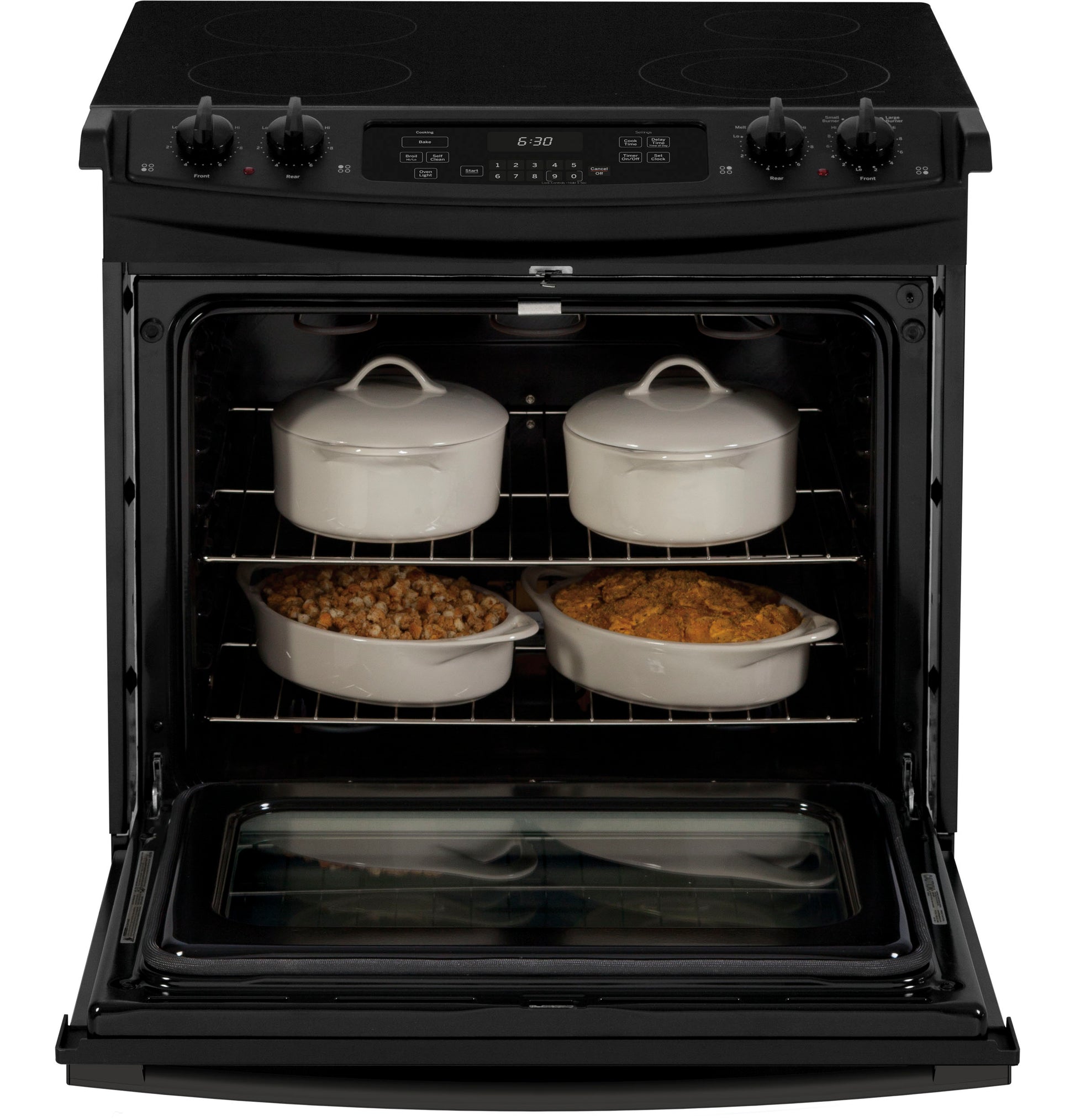 Black drop-in electric range with smooth cooktop and open oven door displaying covered ceramic cookware and casseroles inside