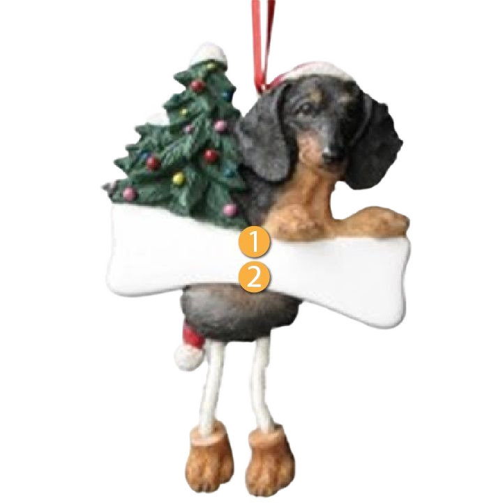 Black dachshund Christmas ornament with dangling legs holding a festive tree and bone for holiday decor