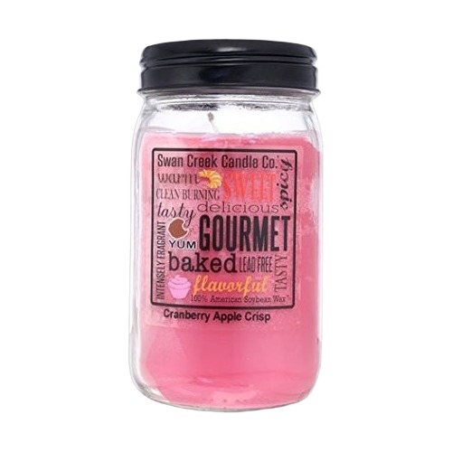 Clear glass jar with pink cranberry apple crisp scented candle and black lid for home fragrance use