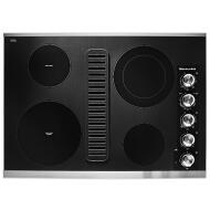 Black and stainless steel electric cooktop with four burners and integrated downdraft ventilation in modern kitchenware collection