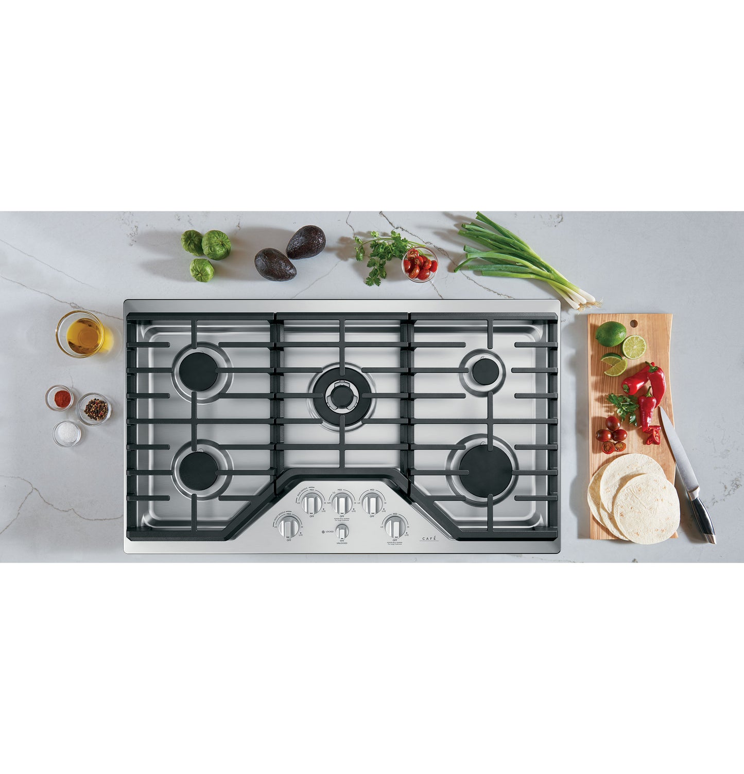 Modern gas cooktop with five burners and stainless steel control knobs in kitchen and cooktops appliances collection