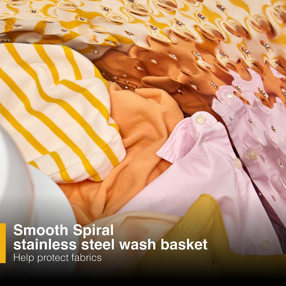 Close-up of colorful clothes gently submerged in water inside a top load washer's stainless steel wash basket