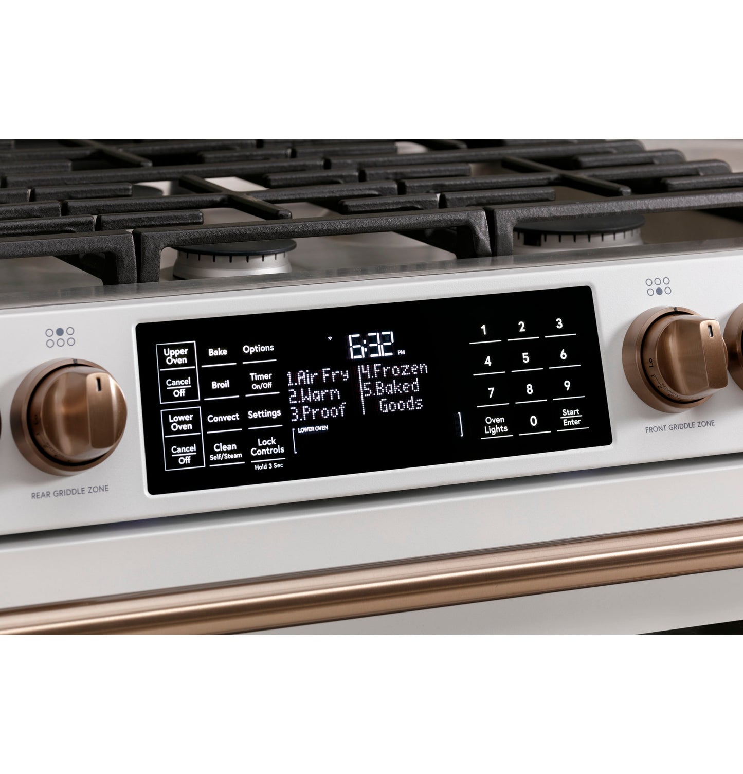 Close-up of control panel on white smart gas double-oven range with bronze knobs from Ranges and Appliances collections