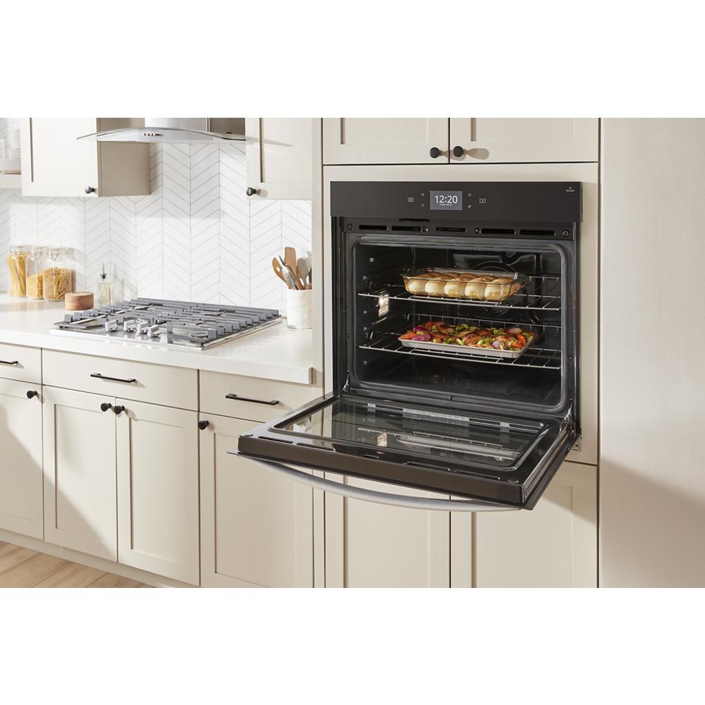 Built-in smart wall oven with air fry cooking multiple dishes inside in modern kitchen and Appliances collections