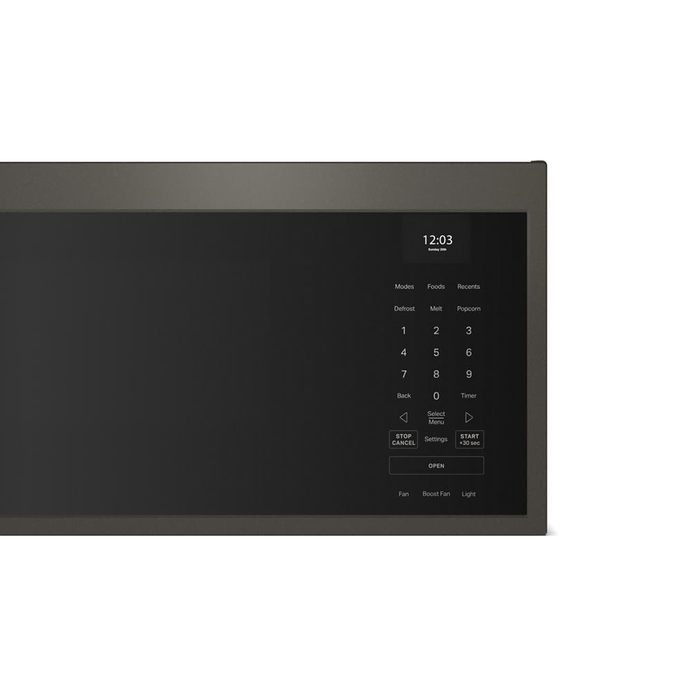 Close-up of black microwave control panel with digital clock, numeric keypad, and smart function buttons from KitchenAid collection
