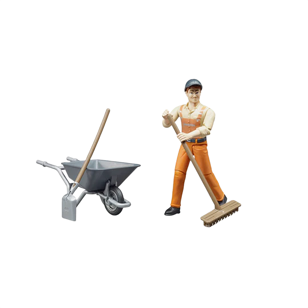 Figure of municipal worker in orange overalls holding broom next to wheelbarrow with shovel and broom handle