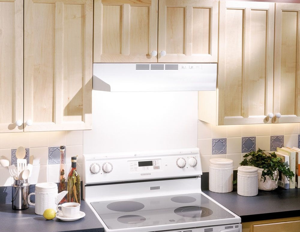 white under-cabinet 24-inch range hood with 2-speed rocker controls and light above electric stovetop in kitchen setting