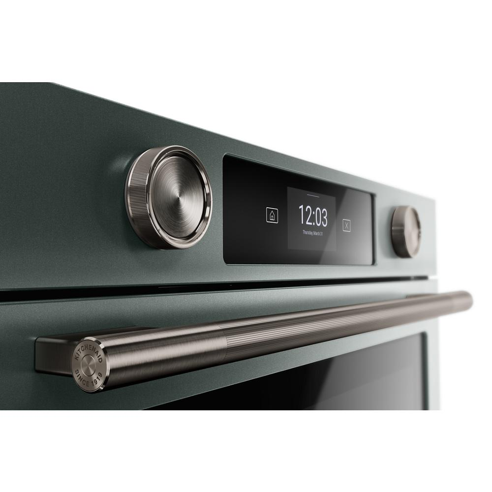 Close-up of green smart electric wall oven with LED display, stainless steel handle, and control knobs in KitchenAid Appliances collection