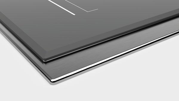 Close-up of dark gray induction cooktop surface mount with sleek framed edge from Thermador kitchen appliances collection