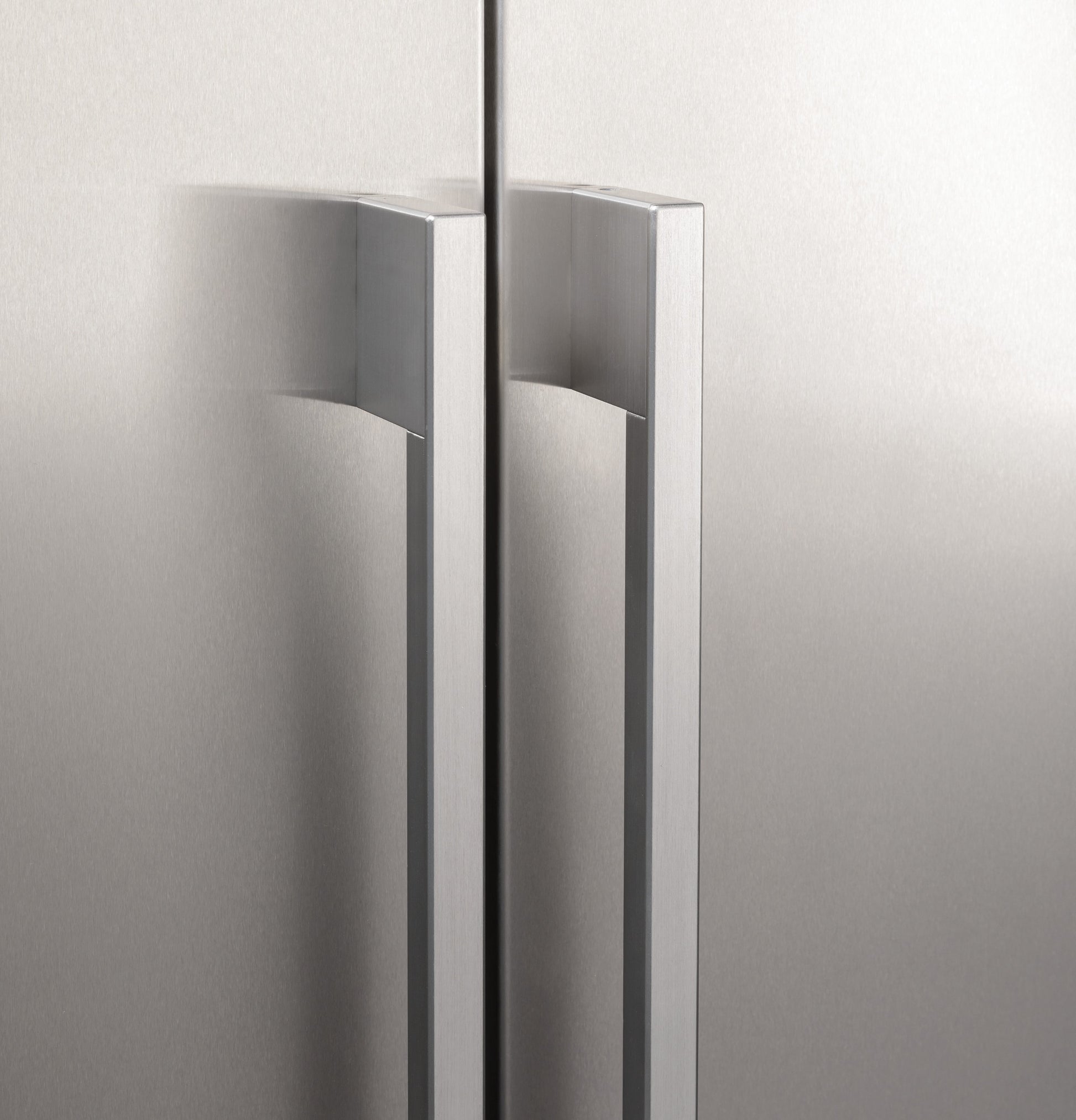 Close-up of sleek stainless steel handles on built-in side-by-side refrigerator in appliances and kitchenware collection