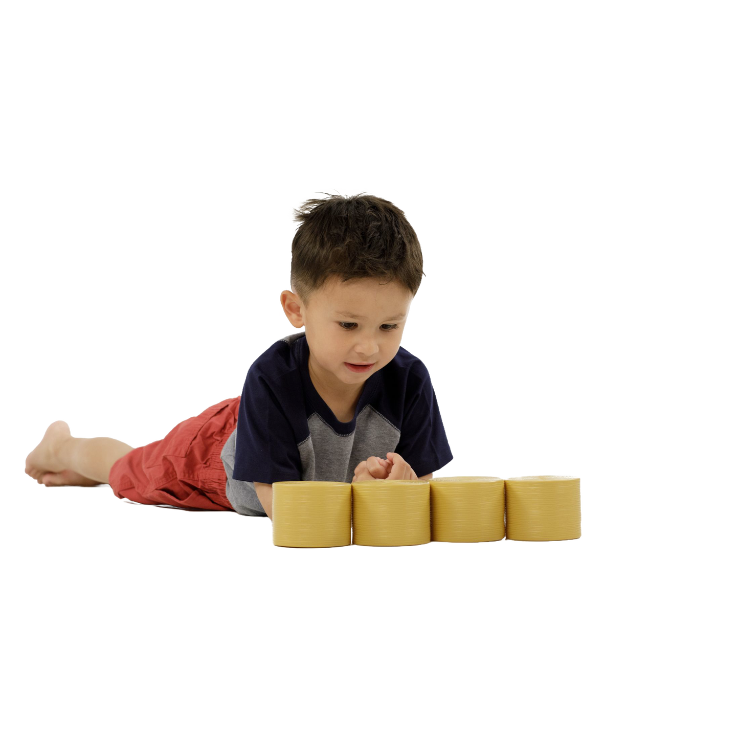 Young boy lying down playing with four ochre-brown round bales toy in Vehicles & Remote Controlled Toys collection under $50
