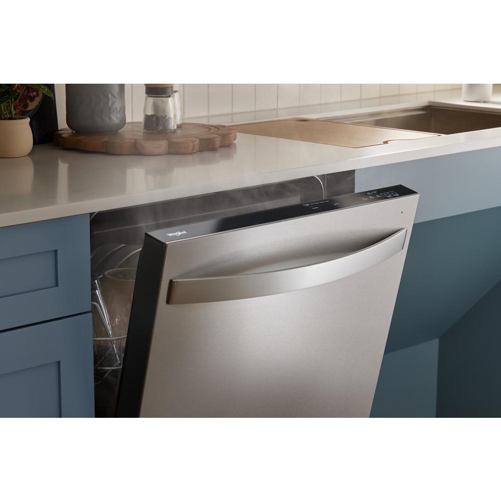 Partially open stainless steel dishwasher with curved handle integrated flush into blue kitchen cabinetry in appliances collection
