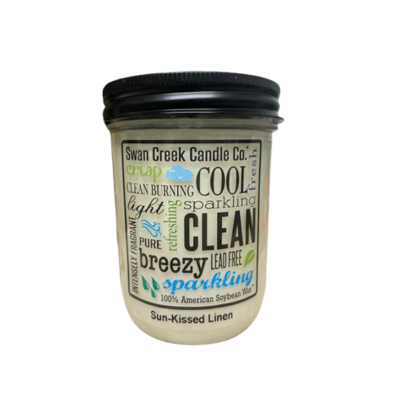 Glass jar candle with black lid featuring clean-burning and fresh scent description text on label