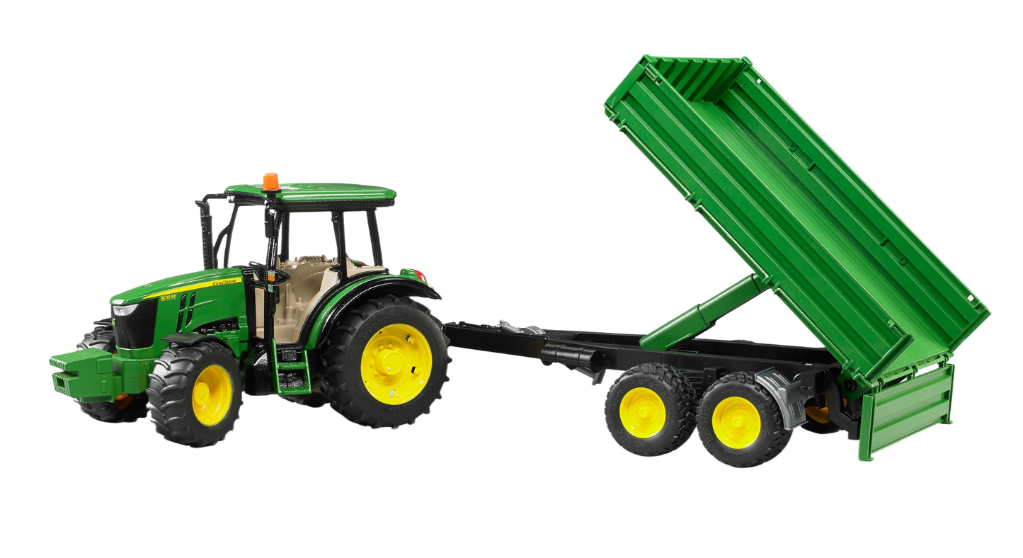 Green Bruder tractor model with yellow wheels hooked to a tilt trailer for realistic farm play scenes