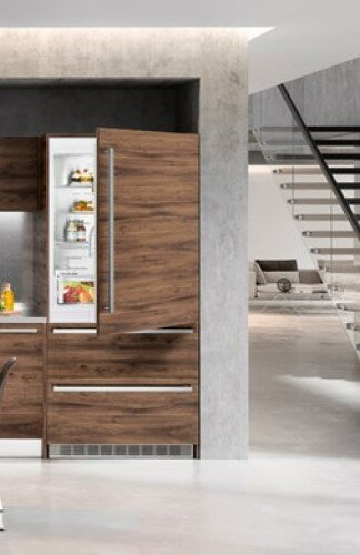 Built-in refrigerator/freezer with wood panel doors, open upper door showing interior shelves in modern kitchen setting