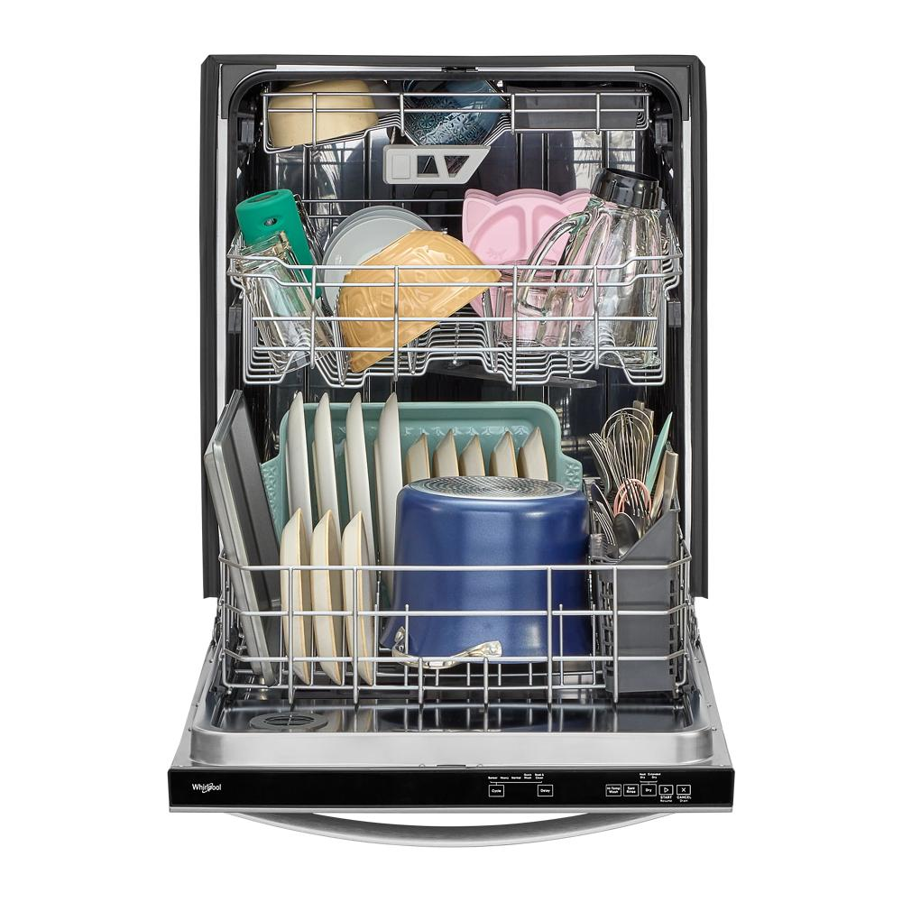Open dishwasher with three racks fully loaded with dishes, bowls, and utensils in a modern kitchen appliance setting