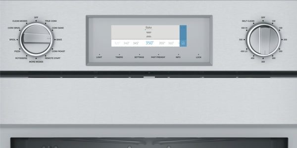 Close-up of stainless steel wall oven control panel with digital display and dual rotary knobs from Thermador collection