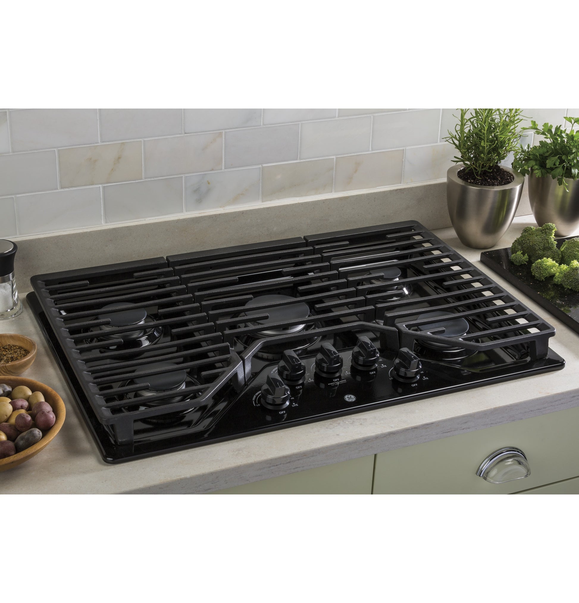 Black 5-burner built-in gas cooktop with dishwasher safe grates on kitchen countertop from Gas Cooktops collection