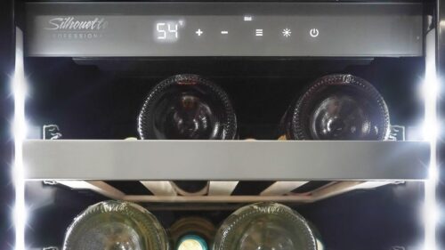 Interior view of slim stainless steel wine cooler with digital control panel and illuminated wooden shelves in Appliances collection
