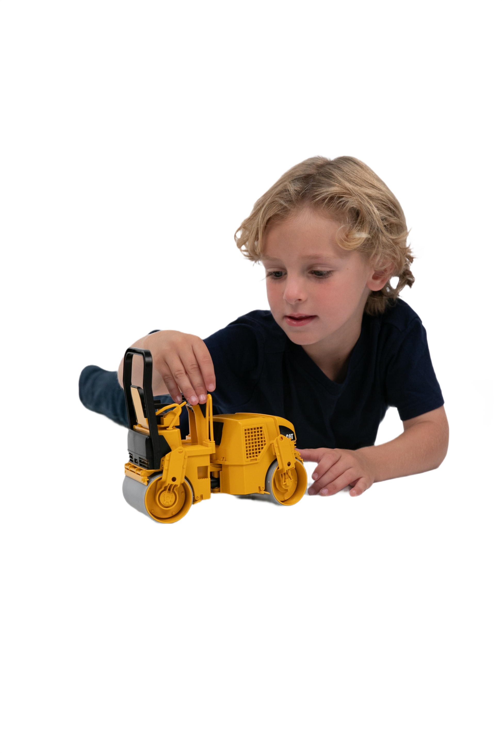 Child playing with a detailed yellow Bruder 1:16 scale CAT asphalt drum compactor model for home improvement fun