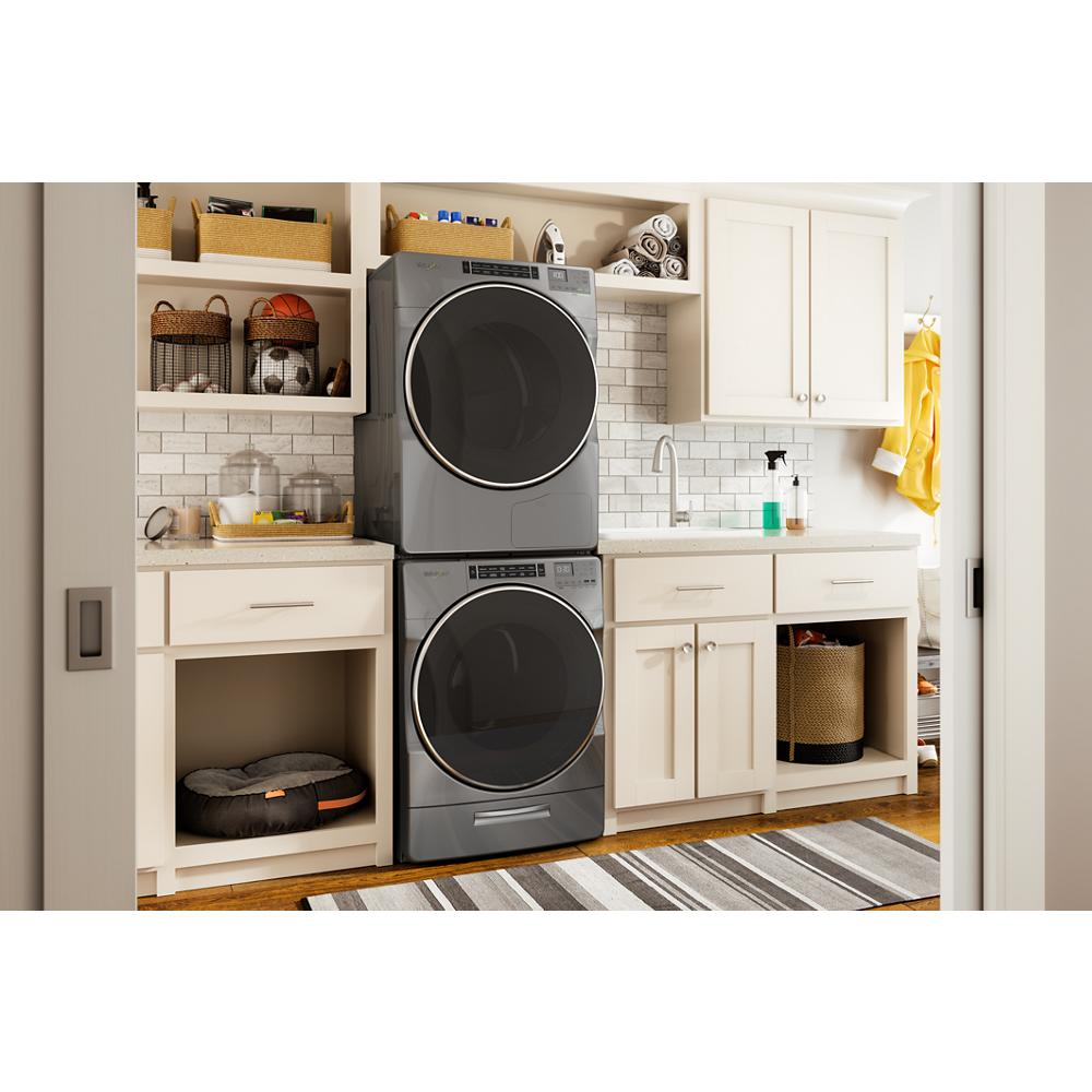 Laundry room with stacked gray front load washer and dryer in white cabinetry from Appliance Parts & Accessories collection