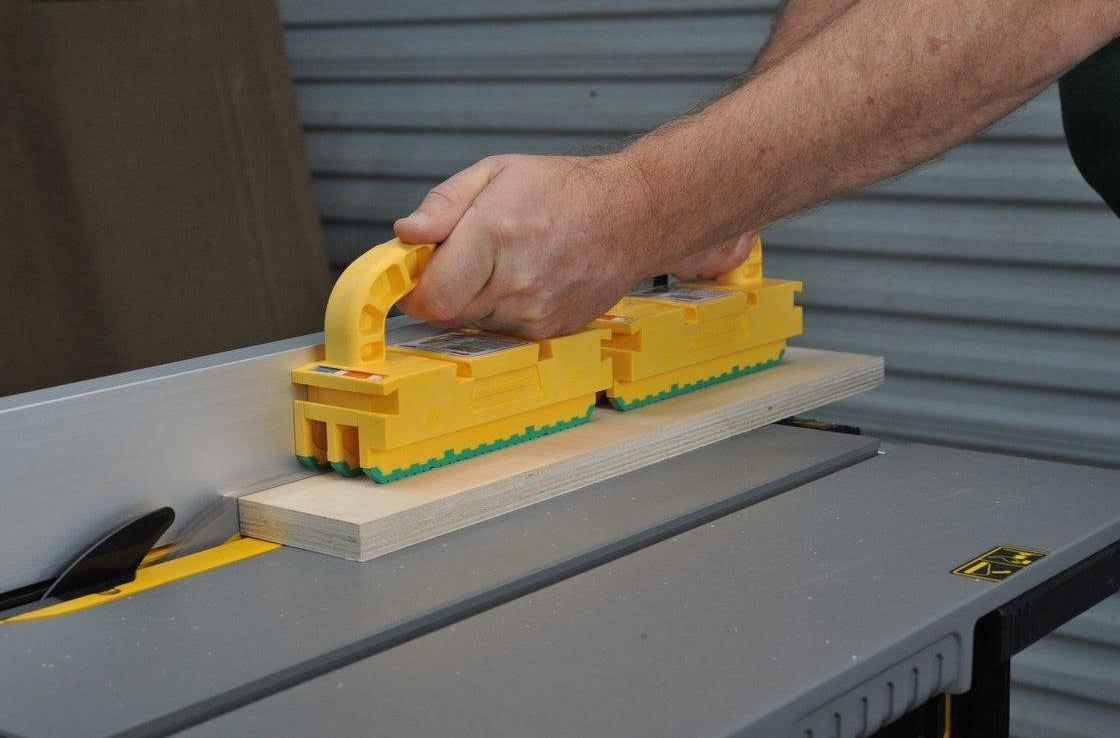 Person using yellow Microjig GRR-RIPPER2 Go Push Block for safe wood cutting on table saw in power tool accessories
