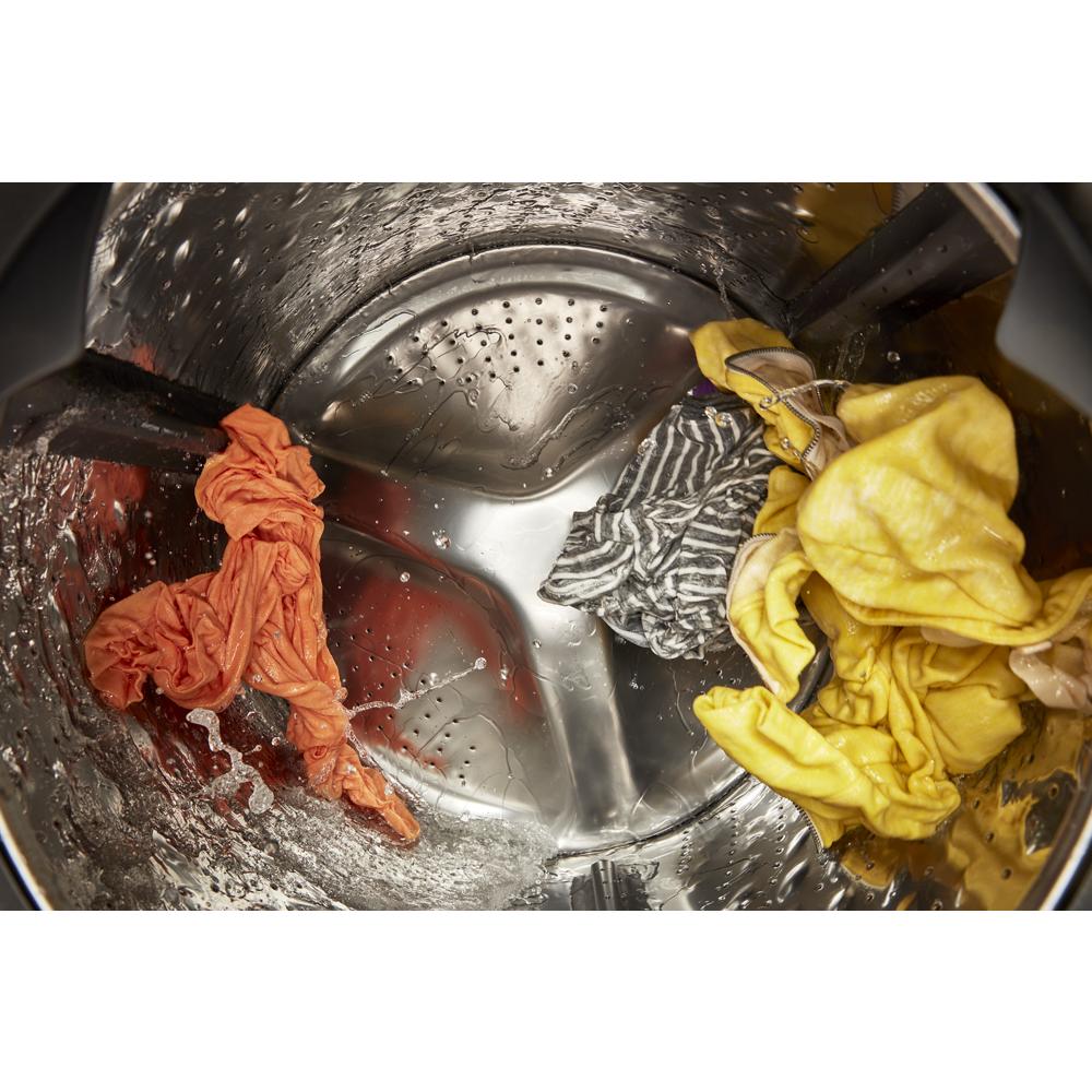 Interior view of ventless washer dryer drum with wet colorful clothes inside in washers and dryers collection