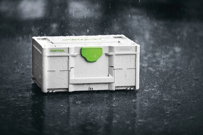 Compact gray and green Festool storage box designed for tool and abrasive storage under rainy conditions