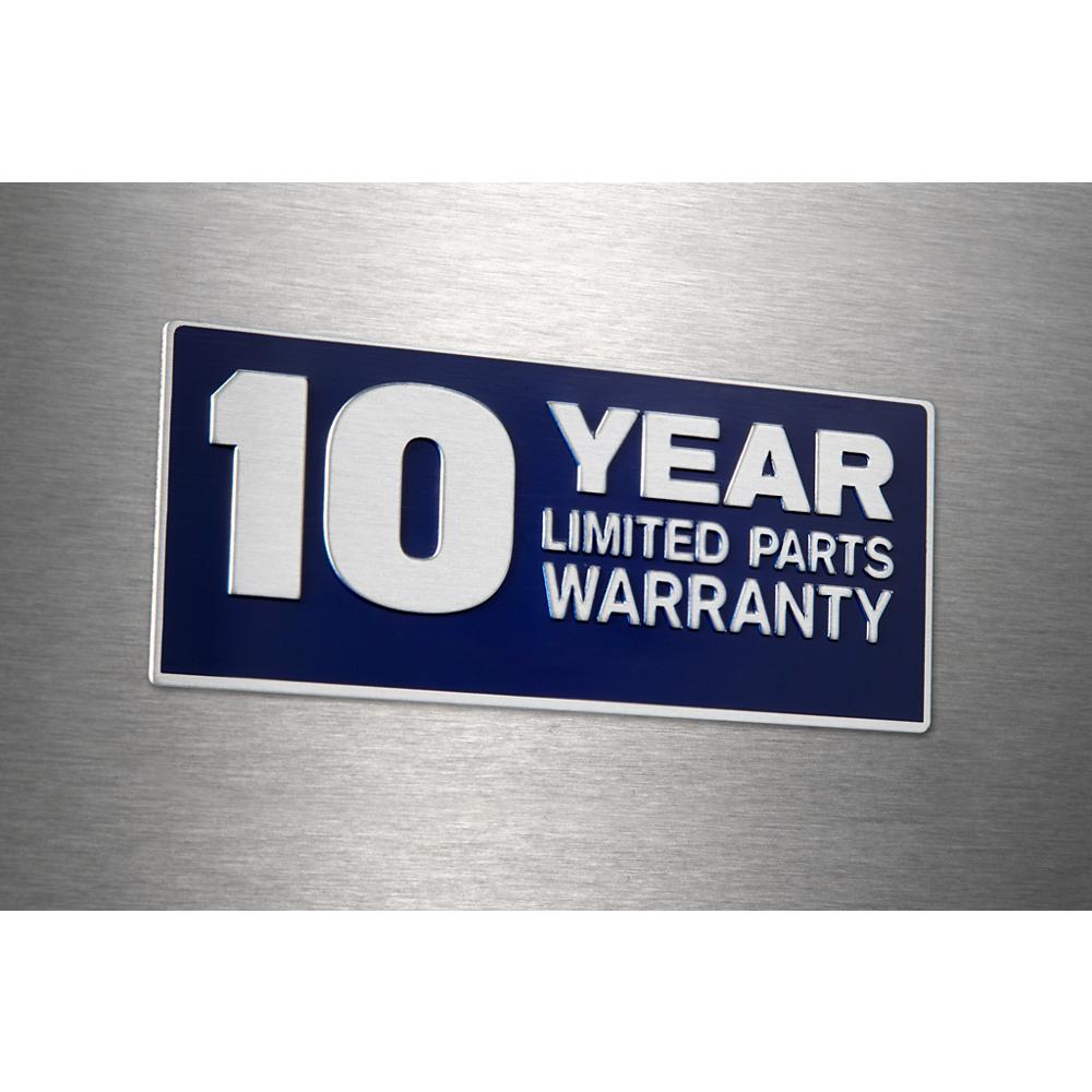 Close-up of metallic appliance badge stating 10 year limited parts warranty on stainless steel surface