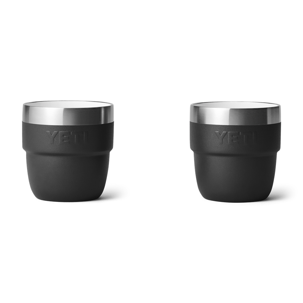 Two black stackable 4 oz. insulated cups with stainless steel rims designed for durable outdoor drinkware use