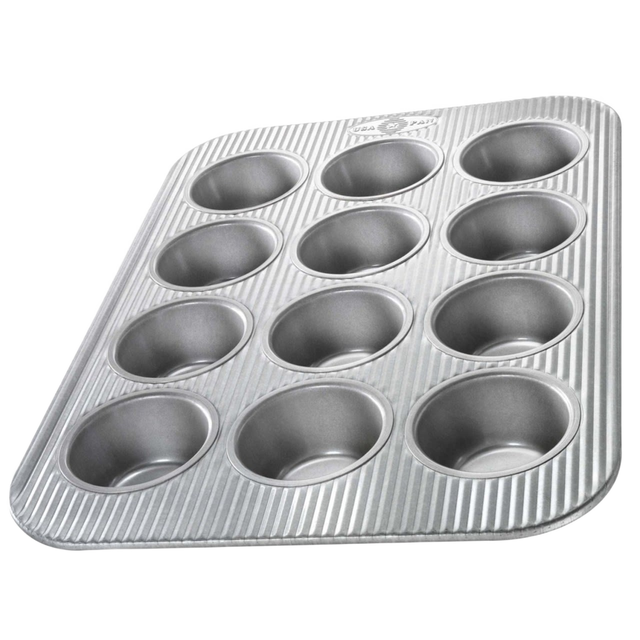 Nonstick metal muffin pan with twelve cups and textured surface for durable home baking use