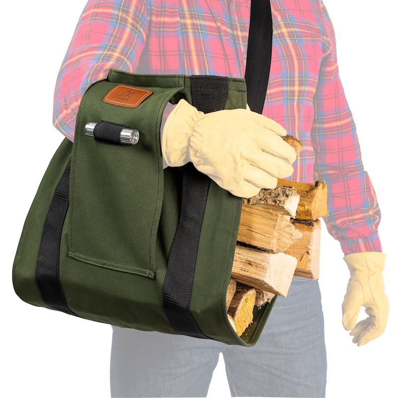 Green heavy-duty fabric sling with adjustable strap carrying split firewood for home improvement wood hauling tasks