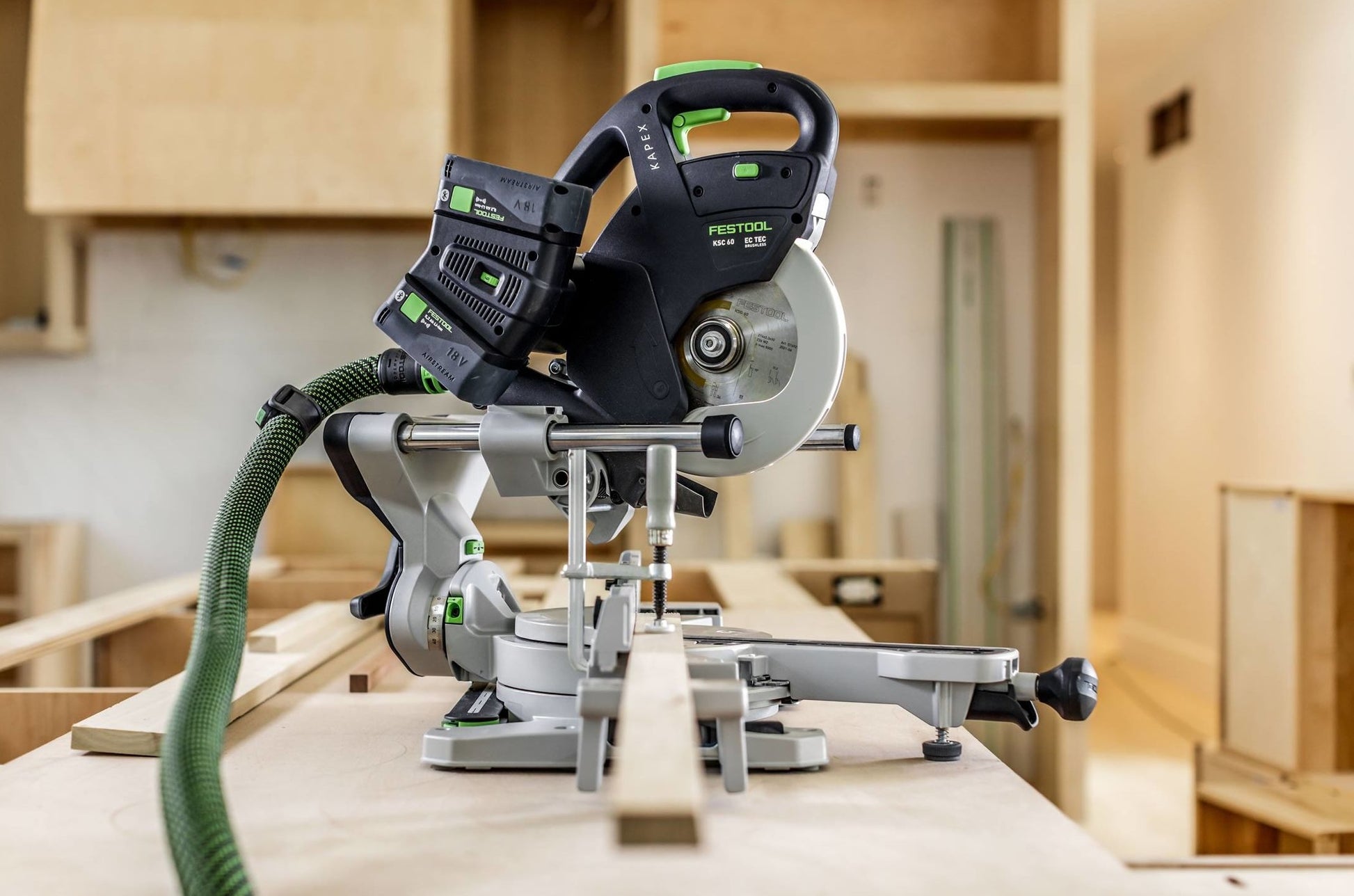 Cordless sliding compound miter saw in a wood workshop setting for precise cutting and home improvement tools