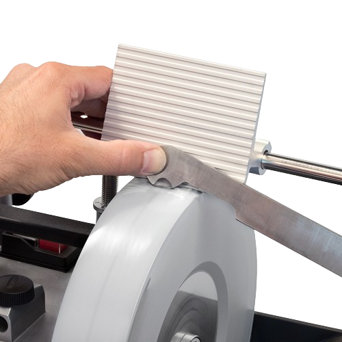 Hand adjusting a tool rest on a sharpening wheel for home improvement and tool maintenance tasks