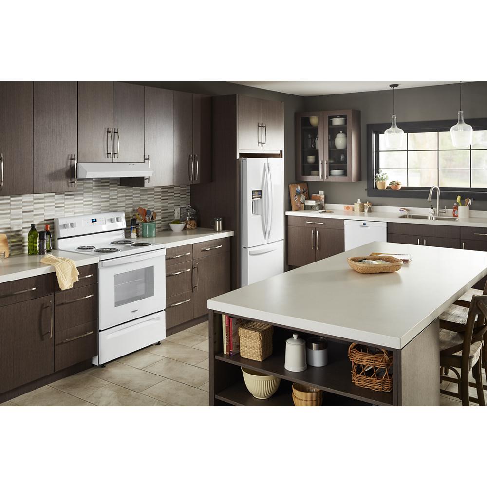 Modern kitchen with white electric range, dark wood cabinets, large island, and stainless steel refrigerator from Appliances collection