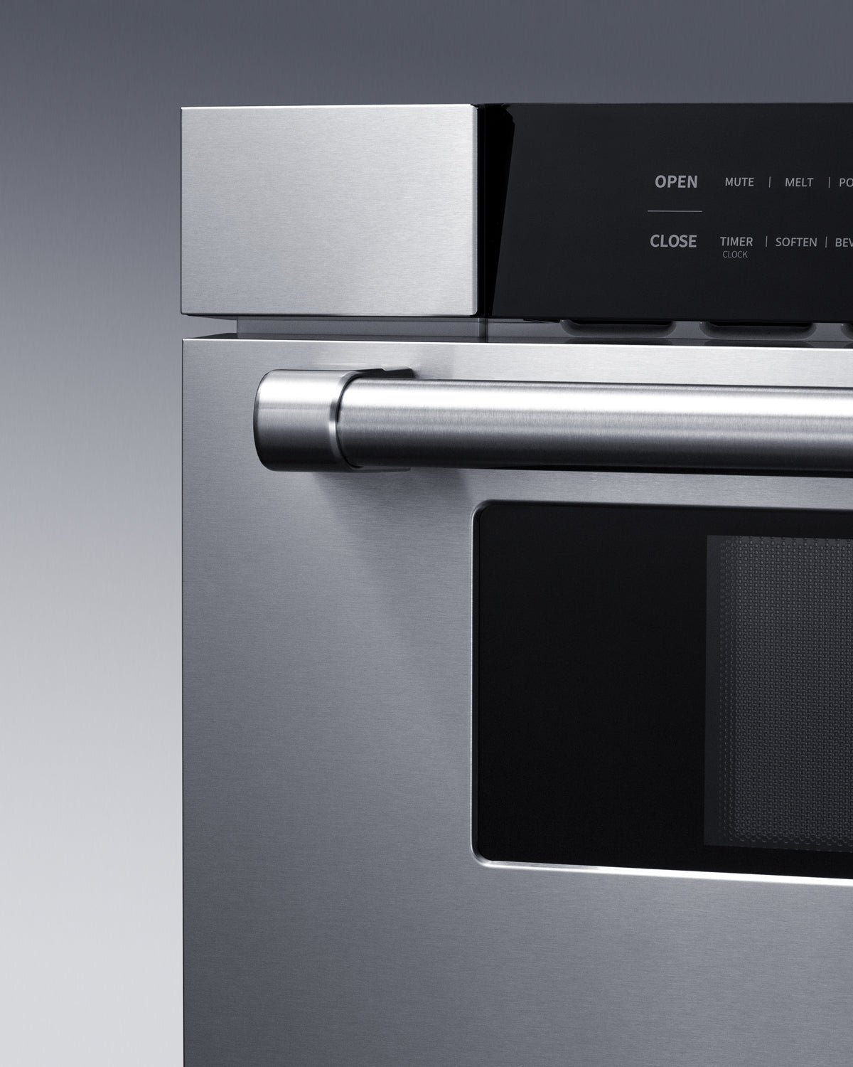 Close-up of stainless steel handle and digital control panel on built-in microwave from kitchen appliances collection