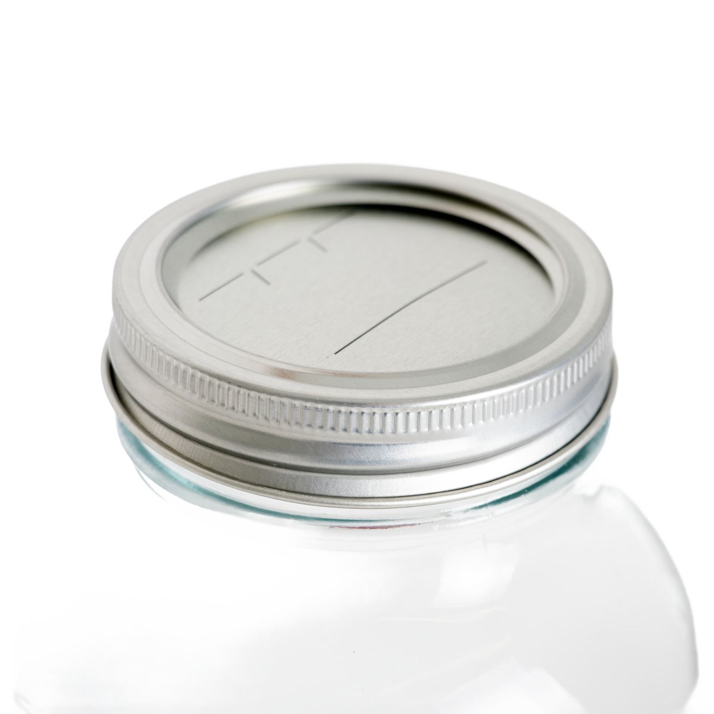 Clear glass jar topped with silver-tone lid and band featuring date-marking lines in kitchenware under $50 collection