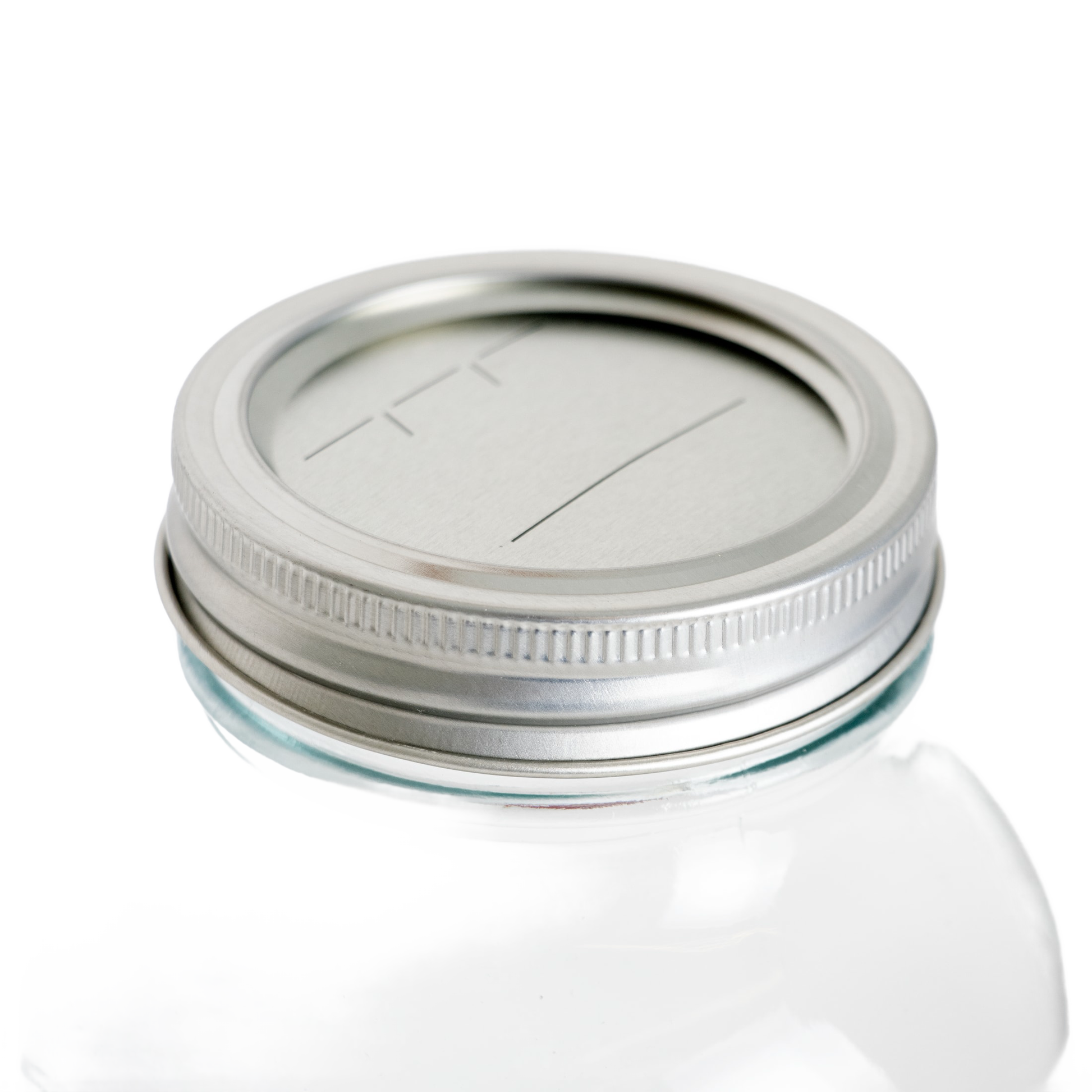 Clear glass jar topped with silver-tone lid and band featuring date-marking lines in kitchenware under $50 collection