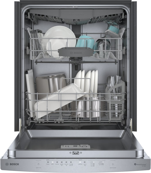Open dishwasher with two racks loaded with plates, bowls, and utensils in modern kitchen appliance setting