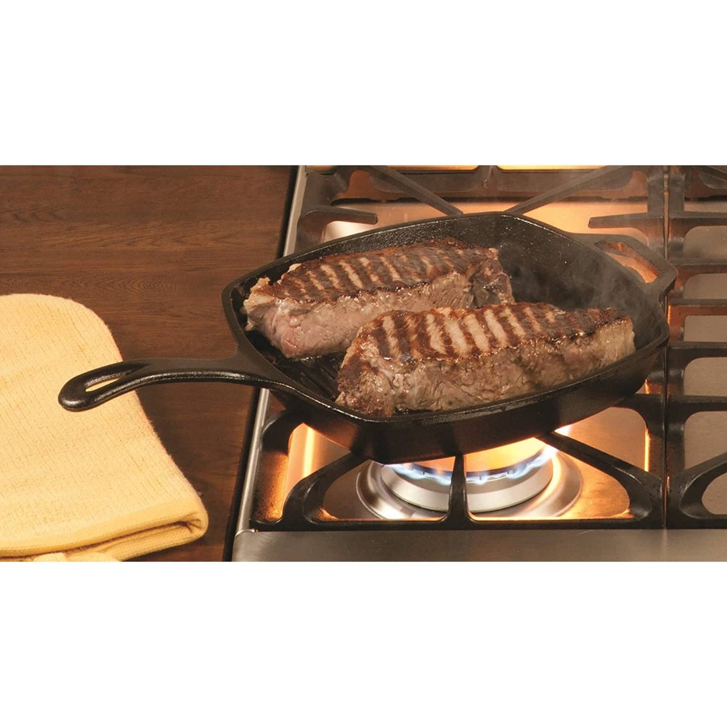 Square cast iron grill pan with ridged surface cooking two steaks on gas stovetop in Kitchenware collections under $100