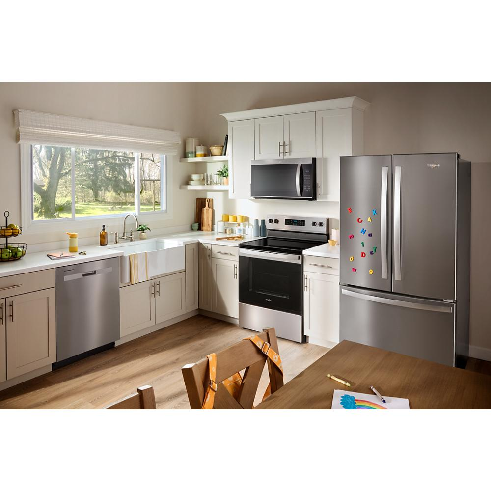 Modern kitchen with stainless steel appliances including an over the range microwave and French door refrigerator