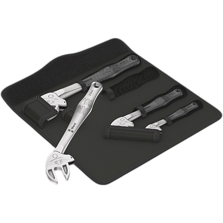 Four-piece set of chrome self-setting spanners with ergonomic handles laid on a black tool mat for home improvement tasks
