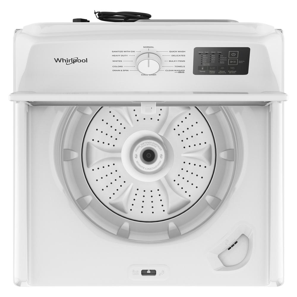 Top load washer interior with agitator and control dial, part of Whirlpool washers and home improvement appliances.