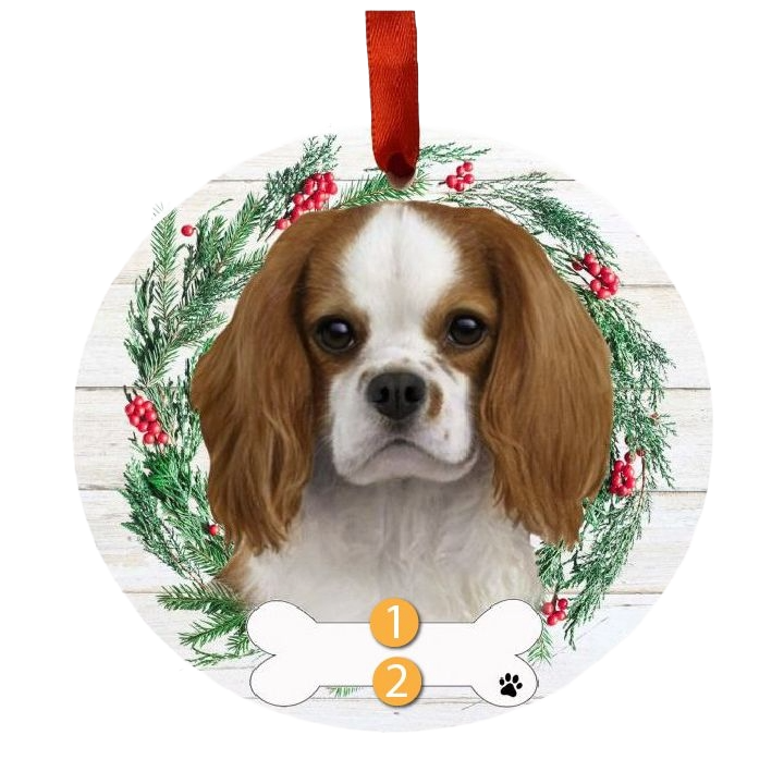 Round Christmas ornament with King Charles Cavalier dog face and festive green wreath with red berries decoration